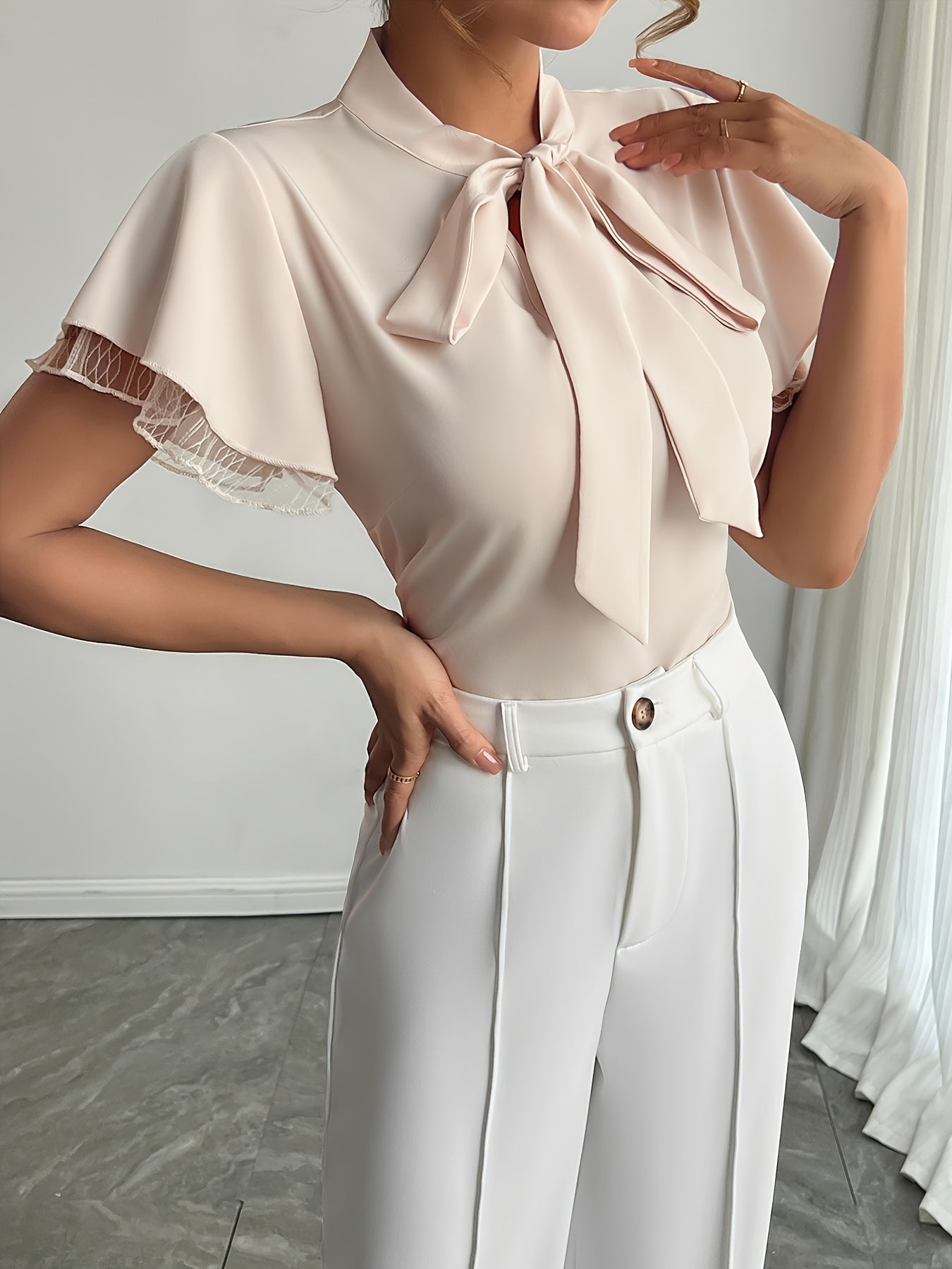 Soft Beige Tie-Neck Blouse with Ruffled Elegance