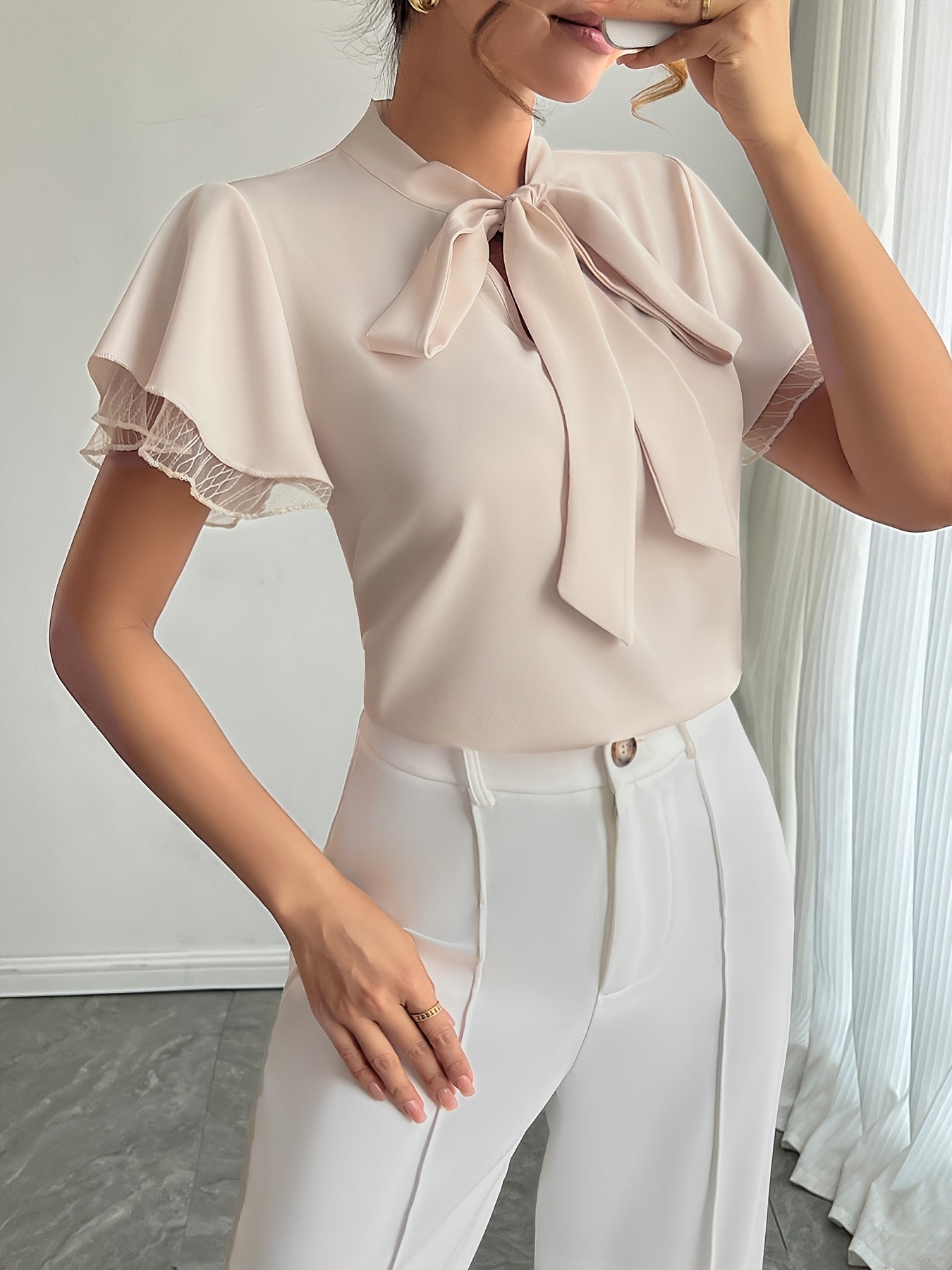 Soft Beige Tie-Neck Blouse with Ruffled Elegance